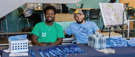 Students at table wearing first generation t-shirts.